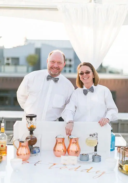 Man and woman servers smiling | Lisa Dupar Catering | Wedding & Event Catering in Seattle