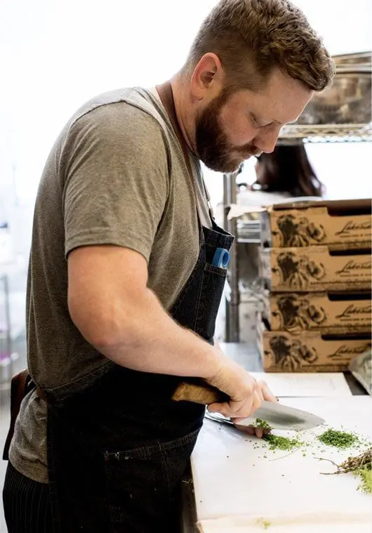 Chef cutting herbs | Lisa Dupar Catering | Wedding & Event Catering in Seattle